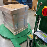 Boxed VIA Freeze Quad strapped and stretch-wrapped on a pallet, positioned on an industrial scale with its digital display visible.